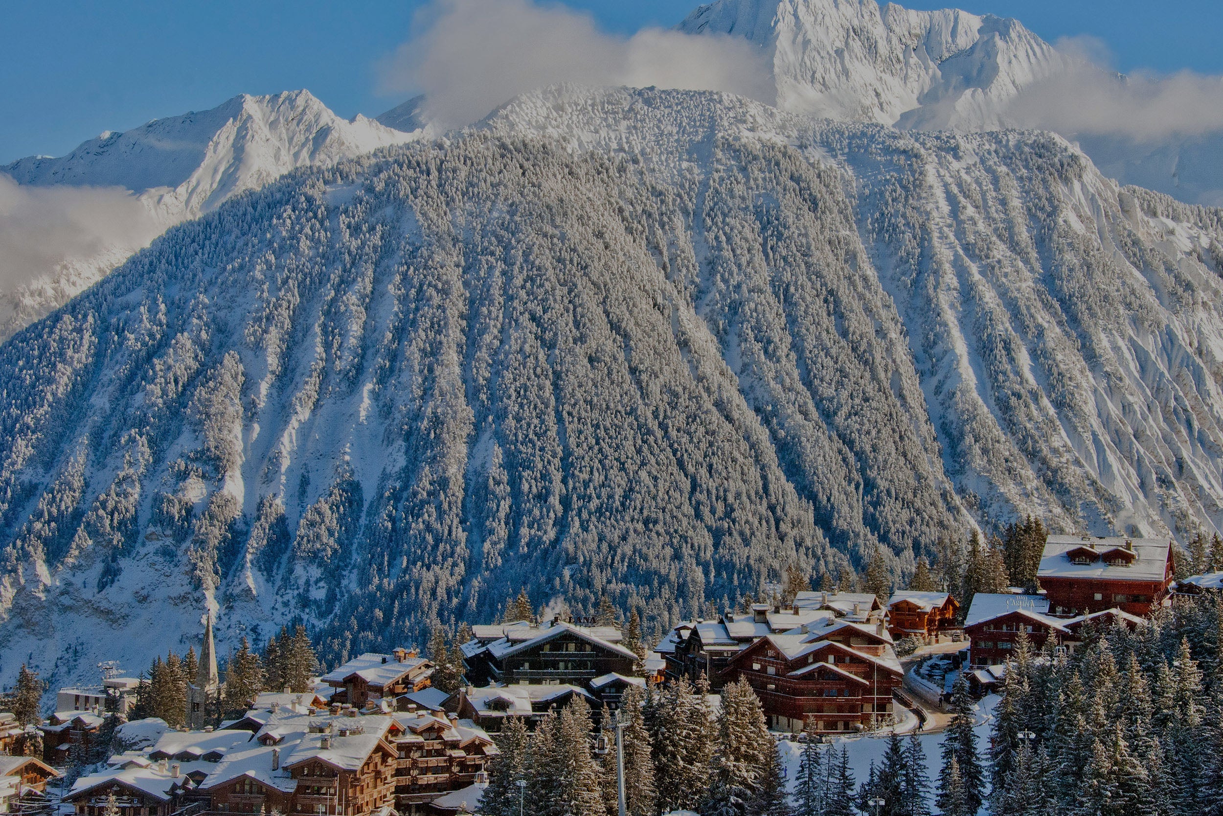 Aerial view of luxury chalets and snow-capped mountains in Courchevel