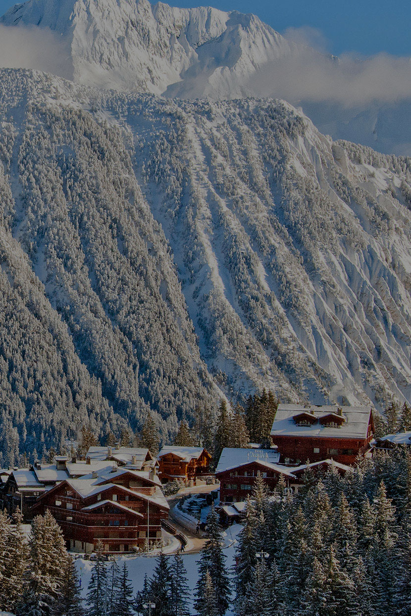 Aerial view of luxury chalets and snow-capped mountains in Courchevel
